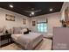 Stylish bedroom featuring a ceiling fan, a plush rug, and a comfy looking bed with many pillows at 802 E Franklin St, Monroe, NC 28112