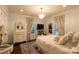 Serene bedroom with a chandelier, soft drapes, and a comfortable bed, creating a peaceful ambiance at 802 E Franklin St, Monroe, NC 28112