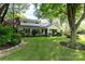 Charming home with a well-maintained lawn, mature trees, and beautiful landscaping at 802 E Franklin St, Monroe, NC 28112