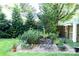 Tranquil garden area with gravel, potted plants, and an iron table set at 802 E Franklin St, Monroe, NC 28112
