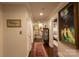 Long hallway with hardwood floors and neutral paint, enhanced by an eye catching, colorful area rug at 802 E Franklin St, Monroe, NC 28112