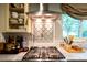 This modern kitchen has a stainless steel range hood and pot filler, and custom backsplash at 802 E Franklin St, Monroe, NC 28112