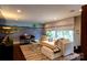 Comfortable living room with a mural, modern furniture, and abundant natural light at 802 E Franklin St, Monroe, NC 28112