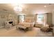 Beautiful main bedroom with a fireplace, elegant chandelier, and soft, neutral colors at 802 E Franklin St, Monroe, NC 28112
