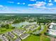 Aerial view of a community with a pond, landscaping, and surrounding trees at 921 Summerlake Dr, Fort Mill, SC 29715