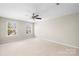 Bedroom featuring neutral carpet, a ceiling fan and two windows at 921 Summerlake Dr, Fort Mill, SC 29715