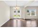 Bright dining room featuring hardwood floors and a stylish chandelier near glass patio doors at 921 Summerlake Dr, Fort Mill, SC 29715