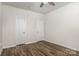 Bright bedroom with hard flooring featuring multiple closet doors at 9416 Cotton Gum Rd, Charlotte, NC 28227