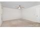 Carpeted bedroom with a ceiling fan at 9416 Cotton Gum Rd, Charlotte, NC 28227