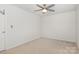 Cozy bedroom featuring neutral carpet, a ceiling fan, and ample space at 9416 Cotton Gum Rd, Charlotte, NC 28227