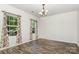 Bright dining room featuring wood floors, large windows, and elegant chandelier at 9416 Cotton Gum Rd, Charlotte, NC 28227