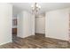 Open dining area featuring wood floors, neutral walls, and a view of the kitchen at 9416 Cotton Gum Rd, Charlotte, NC 28227