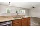 Granite countertops and stainless steel sink with a view into the living room at 9416 Cotton Gum Rd, Charlotte, NC 28227