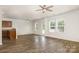 Bright living room with modern ceiling fan, wood floors, lots of natural light at 9416 Cotton Gum Rd, Charlotte, NC 28227