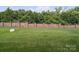 Well-manicured backyard featuring a lush lawn, a brick perimeter fence, and privacy at 9428 Carneros Creek Rd, Charlotte, NC 28214