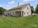 Expansive backyard boasts lush green grass and a covered patio, ideal for entertaining and enjoying the outdoors at 9428 Carneros Creek Rd, Charlotte, NC 28214