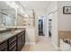 Relaxing bathroom featuring a large soaking tub, dual sinks, and a separate shower for ultimate comfort at 9428 Carneros Creek Rd, Charlotte, NC 28214