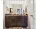 Bathroom with a granite double vanity, decorative lamps, and patterned floor mat at 9428 Carneros Creek Rd, Charlotte, NC 28214