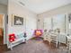 A bedroom with a window for natural light, and colorful chairs and decorations at 9428 Carneros Creek Rd, Charlotte, NC 28214