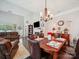 Elegant dining room with a modern chandelier, stylish table settings, and comfortable leather seating at 9428 Carneros Creek Rd, Charlotte, NC 28214