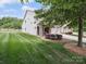 Charming home exterior with well-manicured lawn, covered entryway, and convenient attached garages at 9428 Carneros Creek Rd, Charlotte, NC 28214