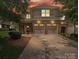 Charming home at sunset featuring a brick facade and a convenient two-car garage, perfect for modern living at 9428 Carneros Creek Rd, Charlotte, NC 28214