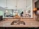 Granite countertops complement the kitchen's design, enhanced by pendant lighting and an open view to the living area at 9428 Carneros Creek Rd, Charlotte, NC 28214