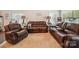 Comfortable living room with plush leather seating, a soft rug, and abundant natural light at 9428 Carneros Creek Rd, Charlotte, NC 28214