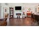 Spacious living room featuring hardwood floors, a fireplace, and decor for a warm and inviting atmosphere at 9428 Carneros Creek Rd, Charlotte, NC 28214