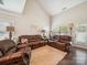 Bright and airy living room featuring vaulted ceilings, plush leather furniture, and neutral decor at 9428 Carneros Creek Rd, Charlotte, NC 28214