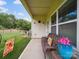 Cozy patio with a cushioned wicker bench, decorative floral pots, and a view of the yard at 9428 Carneros Creek Rd, Charlotte, NC 28214