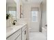 Modern bathroom featuring double vanity, framed mirror, and marble tile flooring at 1070 Bull Dog Ln, Wingate, NC 28174