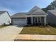 Charming single-story home featuring a two-car garage and a welcoming covered entryway at 1070 Bull Dog Ln, Wingate, NC 28174