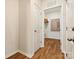 Hallway features wood flooring, doors, and leads to a storage area in this modern home at 1070 Bull Dog Ln, Wingate, NC 28174