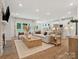Open-concept living room with fireplace, a kitchen and hardwood floors creates a warm, inviting atmosphere at 1070 Bull Dog Ln, Wingate, NC 28174
