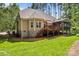 Exterior view showcasing the home's deck, screened-in porch, and lush backyard at 109 Trent Pines Dr, Mooresville, NC 28117
