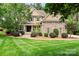 Charming home exterior with stone accents, manicured lawn, and mature landscaping at 109 Trent Pines Dr, Mooresville, NC 28117