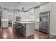 Bright kitchen featuring granite island with barstool seating, stainless appliances, and white cabinetry at 109 Trent Pines Dr, Mooresville, NC 28117