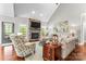 Inviting living room with a stone fireplace, vaulted ceilings, hardwood floors, and stylish decor at 109 Trent Pines Dr, Mooresville, NC 28117