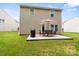 Spacious backyard featuring a patio with a dining set, ideal for outdoor activities and gatherings at 1210 Tabitha Ct, Monroe, NC 28110