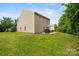 Large backyard with patio dining and green lawn, perfect for outdoor living and enjoyment at 1210 Tabitha Ct, Monroe, NC 28110