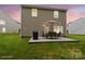 Twilight view of backyard with patio, dining set and grill; great for evening relaxation and entertainment at 1210 Tabitha Ct, Monroe, NC 28110