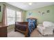 Charming bedroom with natural light from two windows and delightful space-themed decor at 1210 Tabitha Ct, Monroe, NC 28110