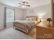 Inviting bedroom featuring a wood-frame bed, neutral decor, and a ceiling fan at 1210 Tabitha Ct, Monroe, NC 28110