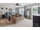 Spacious bedroom features large windows, a ceiling fan, stylish decor and comfortable furnishings at 1210 Tabitha Ct, Monroe, NC 28110