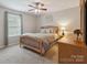 Inviting bedroom featuring a wood-frame bed, neutral decor, and a ceiling fan at 1210 Tabitha Ct, Monroe, NC 28110