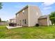 Back exterior of a home with a patio, dining set, and green lawn at 1210 Tabitha Ct, Monroe, NC 28110