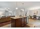Open-concept kitchen island with granite counters and stainless steel appliances, connecting to dining and living areas at 1210 Tabitha Ct, Monroe, NC 28110