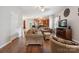 Inviting living room featuring hardwood floors, comfortable seating, and opening to a well-appointed kitchen at 1210 Tabitha Ct, Monroe, NC 28110