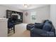 Cozy loft space with a TV, shelving unit, comfortable seating, and natural lighting at 1210 Tabitha Ct, Monroe, NC 28110